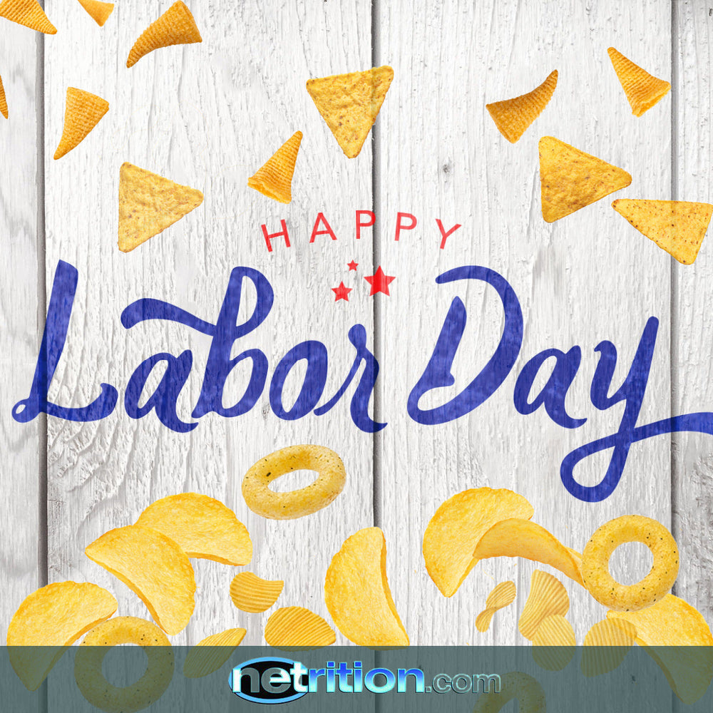 Colorful snacks, including chips and rings, are scattered around the text "Happy Labor Day" in bold blue and red, set against a rustic wooden background.