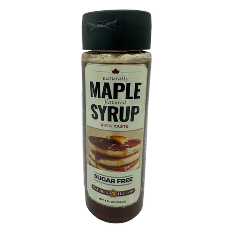 A clear bottle of sugar-free maple syrup features a label with bold text stating "naturally MAPLE flavored" and an image of pancakes drizzled with syrup, indicating its rich taste.