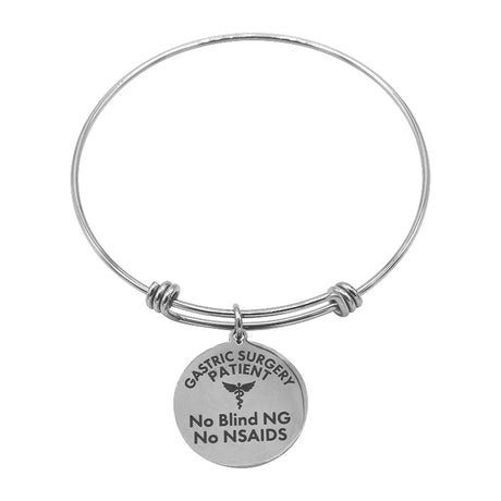 A silver bracelet features a round charm engraved with "Gastric Surgery Patient" and instructions "No Blind NG No NSAIDS," designed for medical identification.
