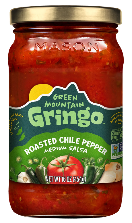 A glass jar of Green Mountain Gringo Roasted Chile Pepper medium salsa, featuring vibrant red salsa with visible ingredients like tomatoes and peppers, labeled with product details and a gold lid.