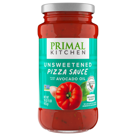 A jar of Primal Kitchen unsweetened pizza sauce, featuring a bright label with a red tomato graphic, highlights that it is made with avocado oil and contains no added sugar.