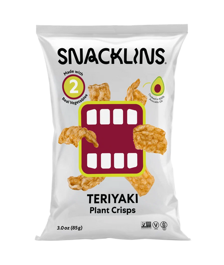 A bag of Snacklins Teriyaki Plant Crisps features a playful design with crispy snacks and highlights that it is made with real vegetables and cooked in avocado oil.