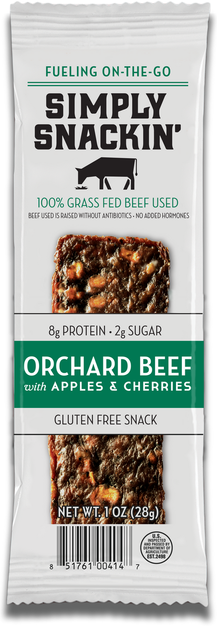 A packaged snack bar labeled "Simply Snackin' Orchard Beef with Apples & Cherries," highlighting its gluten-free, high-protein content and made from 100% grass-fed beef.