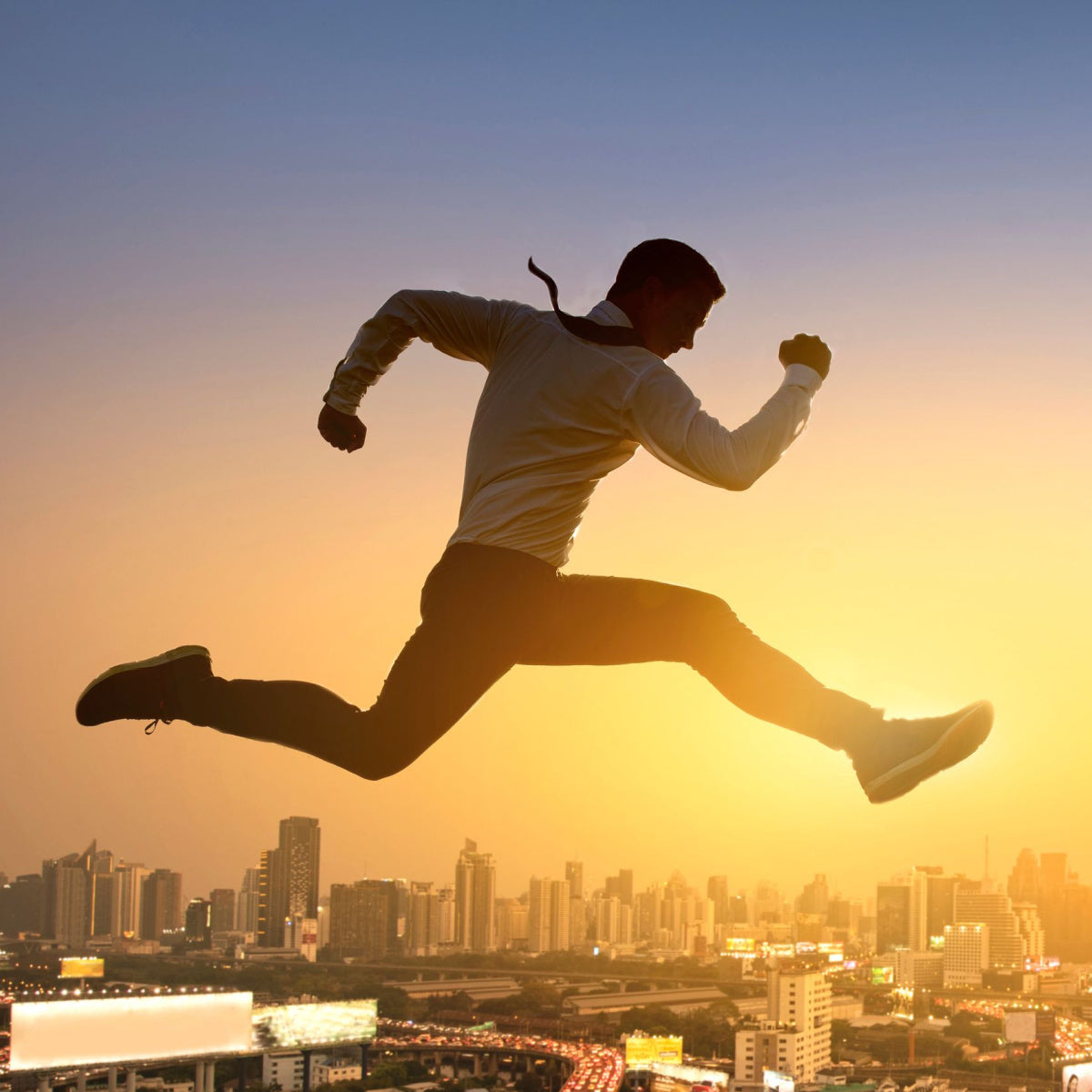 A man in a white shirt and tie leaps energetically against a sunset backdrop, with a city skyline below, symbolizing vitality and the pursuit of boosting energy.
