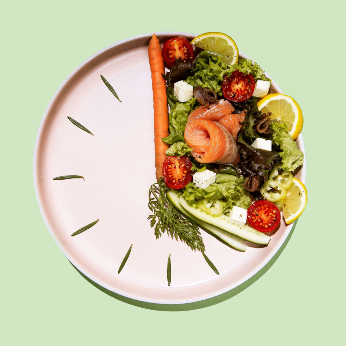 A colorful salad featuring salmon, cherry tomatoes, cucumber, lettuce, and lemon slices is arranged on a pale pink plate designed to resemble a clock, set against a light green background.