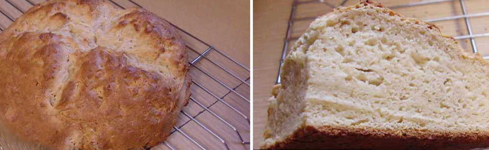 A round loaf of freshly baked bread sits on a cooling rack, showing a golden-brown crust on the outside and a soft, light interior with a few air pockets visible in the cut slice.