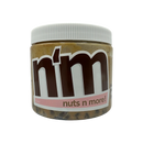 A clear jar of nut butter labeled "n'm" with a brown logo and pink accents, showcasing the product name "nuts n more!" against a black background.