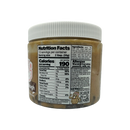 A clear jar of edible cookie dough spread displays the nutrition facts label, including serving size, calories, and allergen warnings for peanuts, milk, and soy.