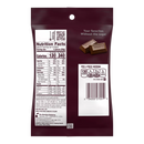 A maroon bag of Hershey's chocolate shows the nutrition facts and barcode on the back, highlighting a serving size of four pieces with 130 calories and no added sugars.