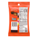 A bright orange snack bag displays nutritional information and a picture of chocolate candies, labeled "Your favorites Without the sugar," with details about servings and ingredients on the back.