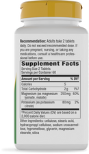 A white supplement bottle with a yellow cap displays the supplement facts, including serving size, calories, and ingredients like magnesium and potassium, along with usage recommendations for adults.