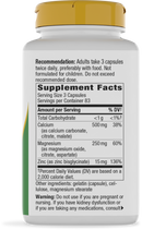 A white supplement bottle with a yellow cap displays the label detailing serving size, ingredients, and nutritional information, including calcium, magnesium, and zinc content.