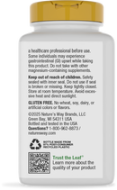 A white supplement bottle with a gold cap displays safety warnings, usage instructions, and information about gluten-free content, made from recycled plastic, with a QR code for product details.