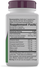 A white supplement bottle with a purple cap displays detailed supplement facts, including ingredients like cinnamon, ginger, and vitamin A, along with dosage recommendations and a warning label.