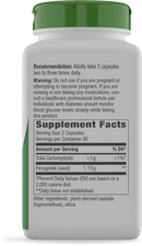 A white bottle with a green cap displays a supplement label detailing usage instructions, warnings, and nutritional information for fenugreek capsules, intended for adult dietary use.