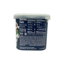 A plastic container displays nutrition facts for a non-dairy creamer, highlighting serving size, calories, and ingredients, with a dark background emphasizing the text.