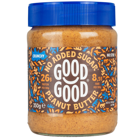 A jar of Good Good crunchy peanut butter with a blue lid displays labels indicating "no added sugar," "26g protein per 100g," and "8.5g fiber per 100g," set against a black background.