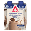 A four-pack of Atkins high protein shakes in creamy chocolate coconut flavor, highlighting nutritional information such as 15g protein, 2g net carbs, and 1g sugar, with an image of the shake spilling.