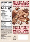 A nutrition label for an Atkins product highlights its low-calorie content, ingredients, and health benefits, surrounded by chocolate and candy pieces to emphasize its appealing taste.