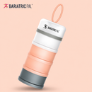 A stackable, multi-colored food container from Bariatric Pal, featuring a gray base, peach and white sections, and a top handle for easy carrying, set against a soft pink background.