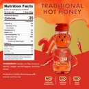 A bear-shaped bottle of Traditional Hot Honey is displayed against a vibrant background, with a nutrition facts label and red chili peppers highlighting its spicy flavor and natural ingredients.