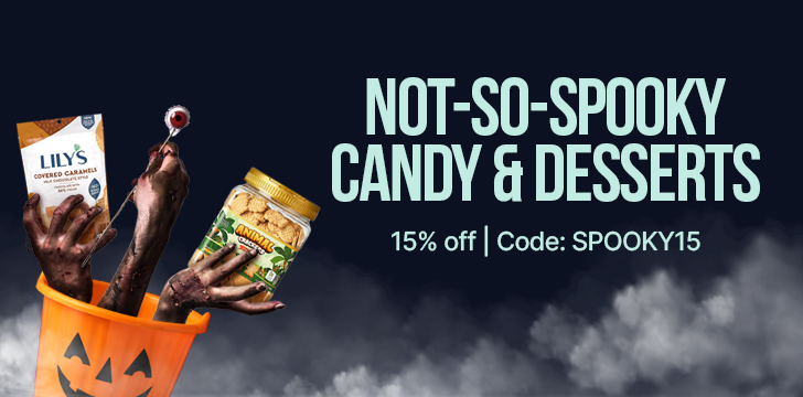 A spooky-themed Halloween bucket holds two candy products, with a hand emerging from it, promoting "Not-So-Spooky Candy & Desserts" with a 15% discount code.