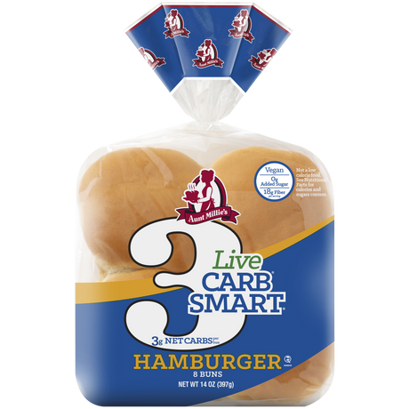 A package of Aunt Millie's Live Carb Smart Hamburger Buns, featuring a blue design, displays the text "3 Net Carbs" and indicates it contains 8 buns, emphasizing its vegan and high-fiber qualities.