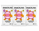Three bags of Snacklins Barbeque Plant Crisps are displayed, featuring a playful design with a smiling mouth graphic and text highlighting that they are made with real vegetables and avocado oil.