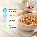 A bowl of cereal with milk sits on a table, accompanied by a box labeled "Bariatric Pal," with text highlighting that it is suitable for breakfast or snack, low fat, lactose-free, and kosher certified.