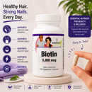 Hand holding a bottle of BariatricPal Biotin 5,000 mcg with 120 vegetarian capsules to support healthy hair, skin, nails and energy metabolism.