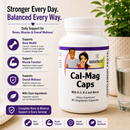 A white bottle of BariatriPal's Cal-Mag Caps dietary supplement shown on a light beige tabletop with a glass of water and blurred greenery in the background. The left side features text with icons about bone, muscle, and overall wellness support.