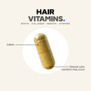 A transparent capsule containing hair vitamins, labeled with "Hair Vitamins" and details about biotin, collagen, and keratin, is shown against a light background, highlighting its size of 0.86 inches.
