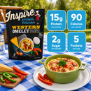 A green bowl filled with a Western omelet topped with sausage and vegetables sits on a table with a blue checkered cloth, beside a packet of Inspire protein omelet mix and colorful sliced peppers.