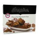 A box of Inspire Choc-a-lot Chip Protein Bars displays a partially broken bar revealing its chewy texture, surrounded by chocolate pieces, with a label highlighting 15g of protein per serving.