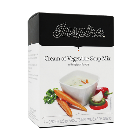 A box of Inspire Cream of Vegetable Soup Mix features a bowl of creamy soup with carrots and herbs, highlighting its natural flavors and suggesting easy preparation for a comforting meal.