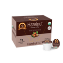 A brown box of organic hazelnut flavored coffee with a logo and information about its low acidity, containing 12 single-serve cups, is displayed against a plain background.