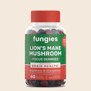A clear bottle of "Fungies Lion's Mane Mushroom Focus Gummies" featuring a red lid, with a label highlighting blueberry and strawberry flavors, and stating it supports brain health, set against a light beige background.
