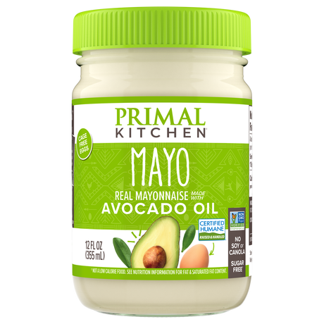 A jar of Primal Kitchen mayonnaise made with avocado oil, featuring a bright green lid and label, highlights its ingredients and certifications, emphasizing it's made with cage-free eggs and is sugar-free.