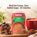 A container of Nestlé Zero hot cocoa mix is displayed alongside a steaming cup of cocoa and chocolate pieces, highlighting its zero added sugar and 25 calories per serving.