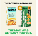 Two boxes of Kaizen Mac & Cheese are displayed side by side, showcasing a new design on the right with highlights on protein content, while the left features the original packaging.