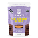 A purple bag of Lakanto Peanut Butter Cups featuring dark chocolate, highlighting "2 net carbs," "gluten free," and "no sugar added," with stacked cups visible in the foreground.