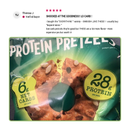 A brightly colored package of low-carb protein pretzels features a circular pretzel shape, with text highlighting "6g net carbs" and "28g protein" per pack, set against a vibrant green background.