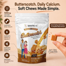A stand-up 90 count bag of BariatricPal Butterscotch flavored calcium soft chews is shown on a warm beige background with marketing text and icons. A human hand holds a single square butterscotch chew on the right side.