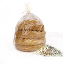 A clear plastic bag contains several stacked cookies, with a small pile of colorful sprinkles beside it on a white background.