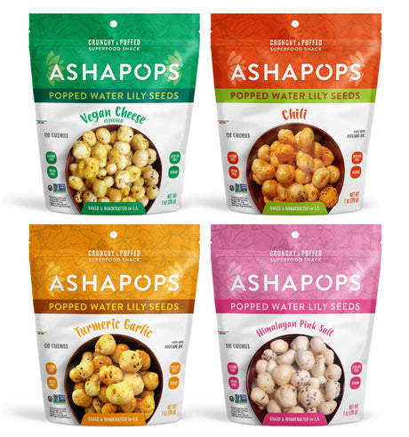 Four colorful bags of Ashapops popped water lily seeds are displayed, featuring flavors: Vegan Cheese, Chili, Turmeric Garlic, and Himalayan Pink Salt, each labeled with calorie information.