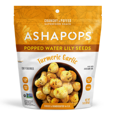 A bag of Asha Pops Popped Water Lily Seeds in Turmeric Garlic flavor, featuring a bowl of crunchy snacks, labeled as gluten-free, vegan, and handcrafted, with a bright orange and white design.