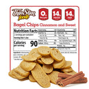 Cinnamon-flavored bagel chips are piled in front of a nutrition facts label, highlighting 0 net carbs, 14 grams of protein, and 14 grams of fiber per serving, with cinnamon sticks beside the chips.