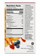 A nutrition facts label details the contents and ingredients of a protein product, featuring information on calories, fats, protein, and allergens, with blueberries and syrup in the background.