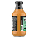 A bottle of zero sugar sauce with a creamy orange color, featuring a black cap and a label listing ingredients and nutritional information, positioned against a plain background.