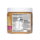 A jar of birthday cake protein spread displays nutrition facts, ingredients, and allergen warnings, with a colorful label featuring a cake design, highlighting its peanut and milk content.